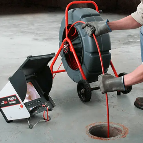 Plumber using drain inspection camera